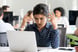 Office worker frowns at computer screen