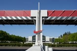 Nike logo in front of a building.