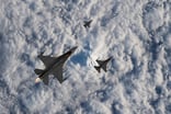 Fighter Jets Flying Over Clouds