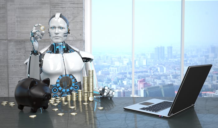 A humanoid robot counting coins on a black desk with a soaring city view.