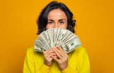 Person holding a stack of bills