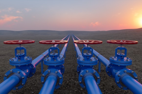 Oil and gas pipelines shown at sunset.