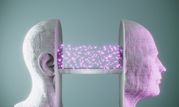 A bust of a human face is split in two, connected by digital ones and zeros. 