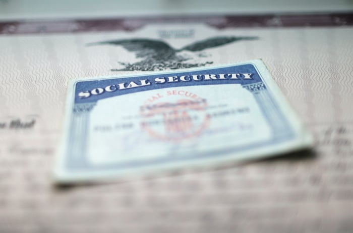 A Social Security card on a document showing an eagle with wings extended.