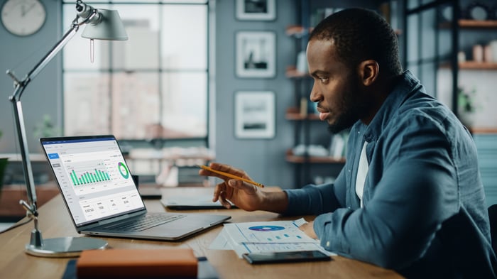 Person examining a graph on their laptop.