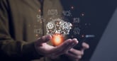artificial intelligence icon floats about outstretched hand.