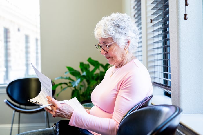 Person reading medical paperwork.