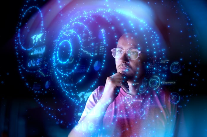 A person looking at spheres created by points of light.
