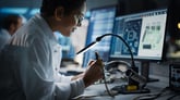 Person looking at computer chip in a factory