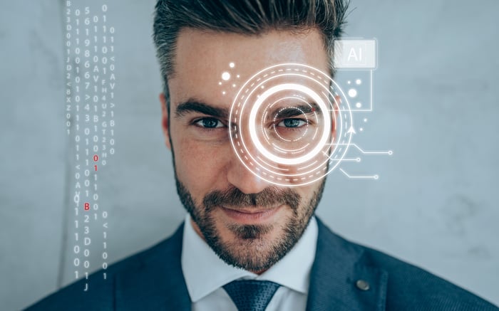 A man in a suit staring straight ahead with a digital graphic overlayed over his eyes. 