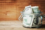 jar full of hundred dollar bills money savings