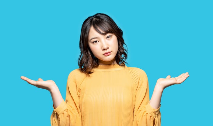 A person with their hands up in frustration.