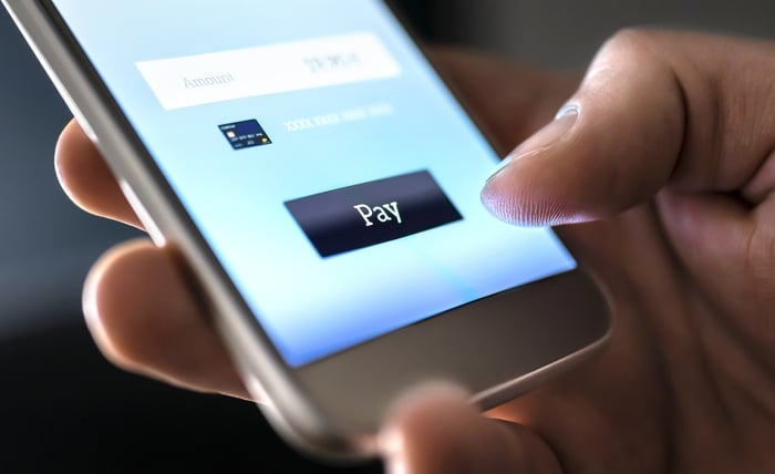 A smartphone with a pay button on it.