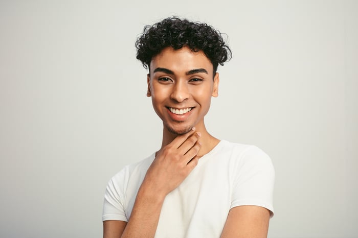 Someone in a white t-shirt is smiling.