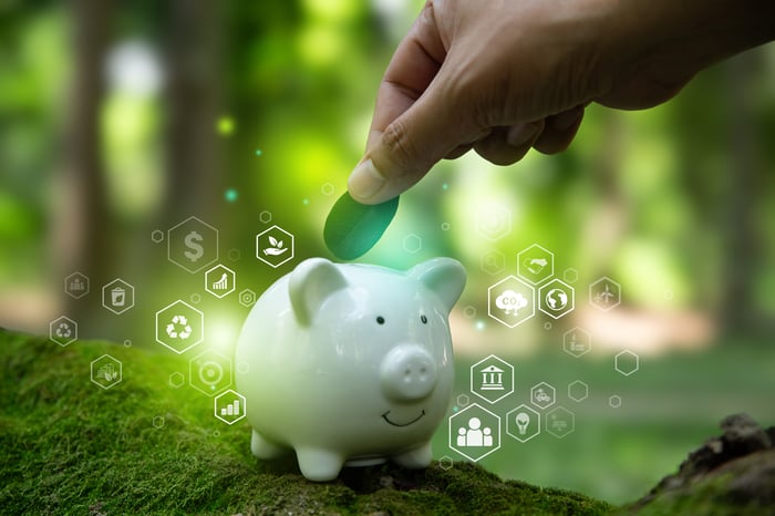 placing money in piggy bank