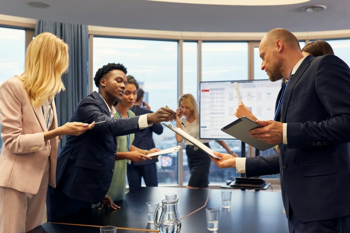 People at a business meeting looking at a report.