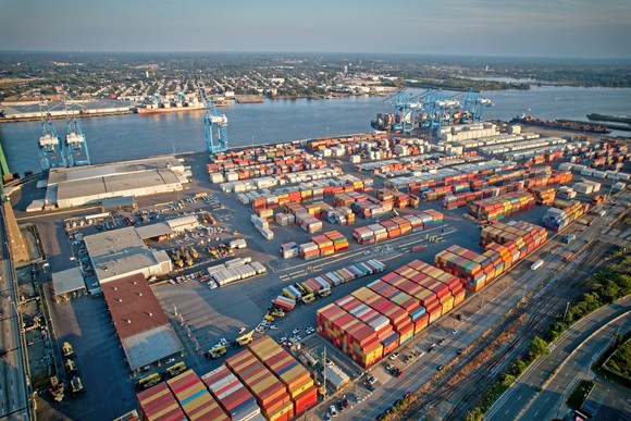 A port containing cranes, shipping containers, and other infrastructure.