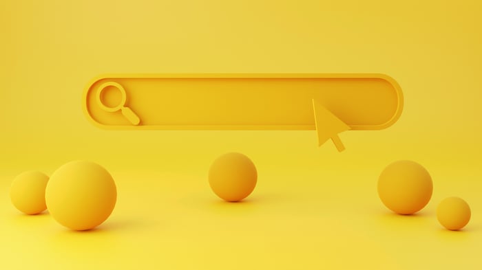 Abstract graphic of a yellow search bar with five spheres in the foreground.