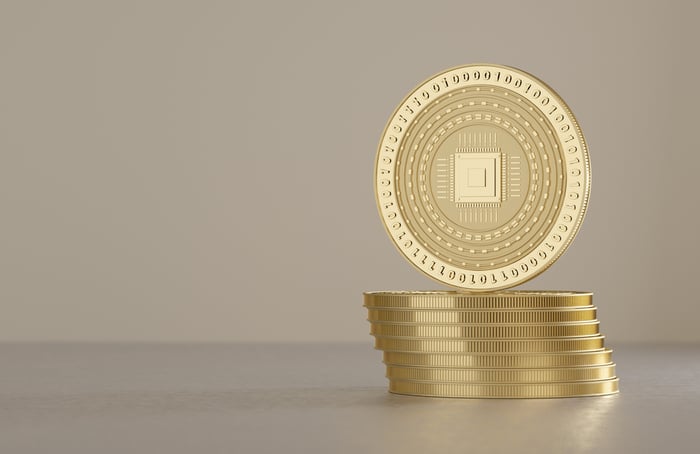 Stack of gold coins with digital 1's and 0's on them.