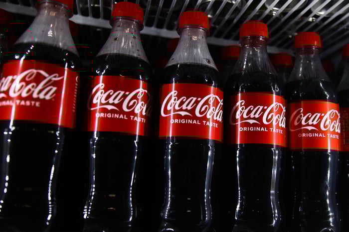 Coke bottles on a store shelf.