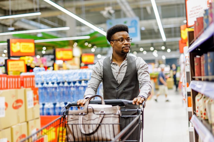 A person pushing a shopping cart.