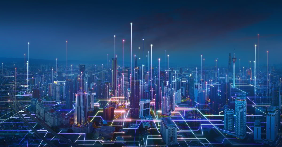 Abstract graphic of beams of light coursing through a city skyline, illustrating the growing interconnection of the physical and digital world.