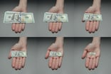 25_08_02 A series of hands with larger and larger sized paper money in them _MF Dload GettyImages-1453845554-1200x798-36b7a2e