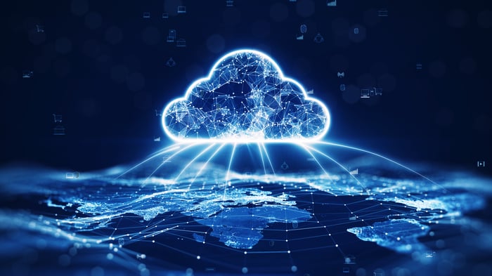 A drawing of a digital-looking cloud with lines protruding from it, connecting to various places on a global map.