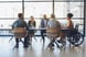 23_11_07 A group of people in a meeting room talking at a table _MF Dload GettyImages-1425293645