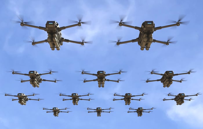 A group of drones flying in the sky. 