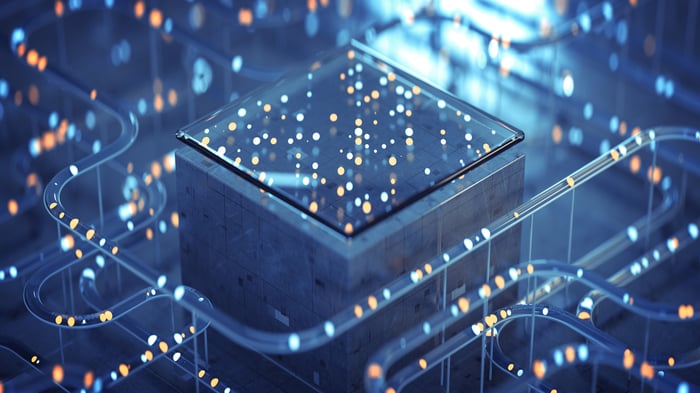 Abstract design of a computer chip on a block surrounded by tubes of light.
