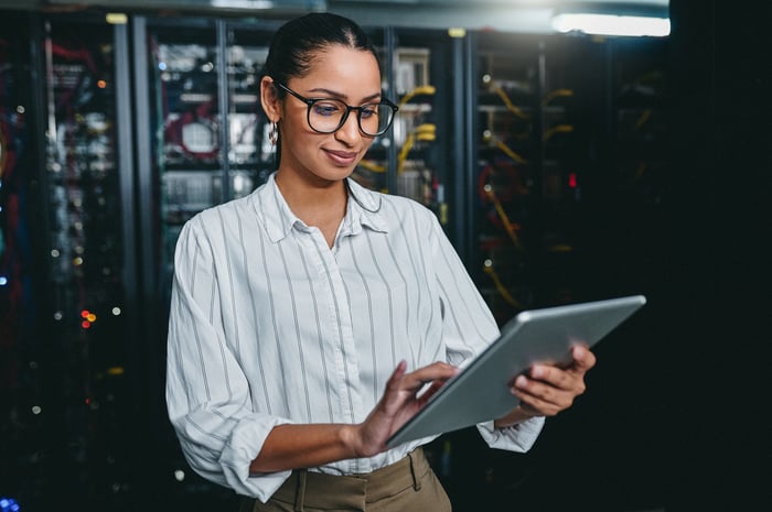 Person in a data center using a tablet computer.