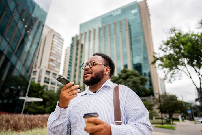 Person uses smartphone speaker.