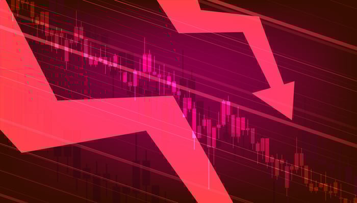 Two red arrows going down over a stock chart.