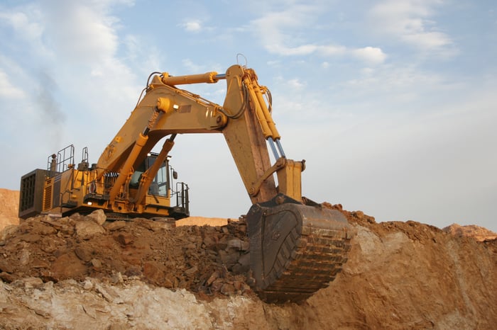 A backhoe digging at a mine.