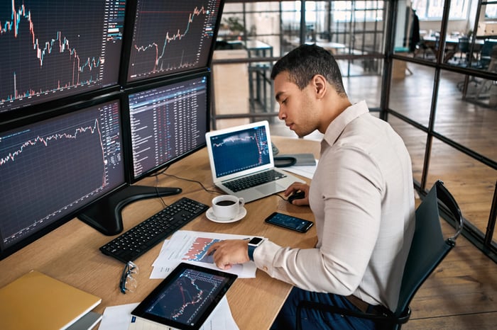 Highly engaged investor with multiple screens.