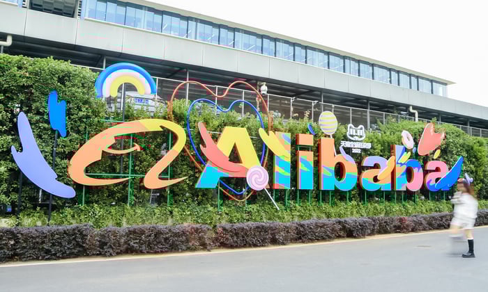 A colorful Alibaba logo on a hedge.