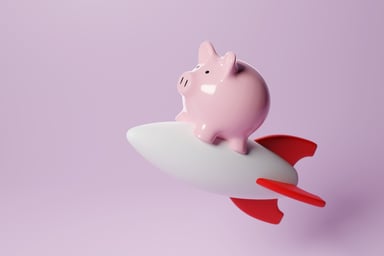 24_10_16 A piggy bank riding a rocket ship _MF Dload GettyImages-1498519579-1200x800-5b2df79