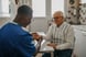 22_01_17 A medical professional working with an older adult _GettyImages-1289420156