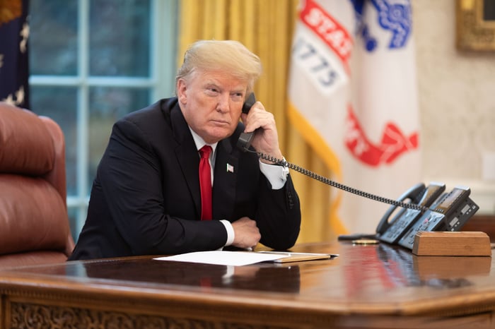 President Donald J. Trump speaks on the phone in the Oval Office.