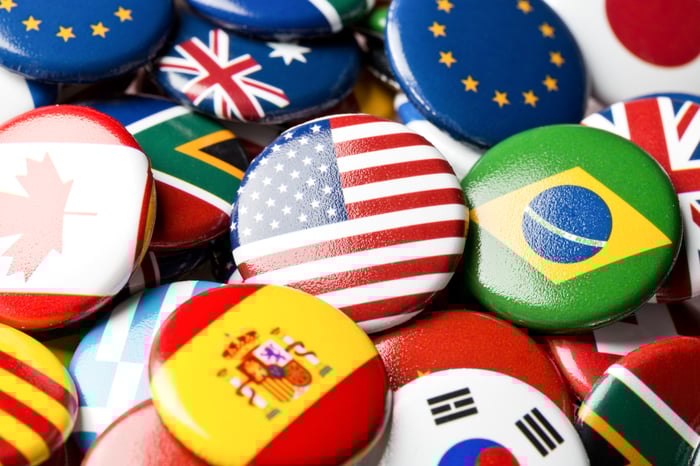 A close-up of round badges with various world flags.