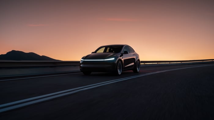 A car driving on the road in the evening.