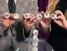 25_09_04 Two people holding up lottery balls that spell out WINNER _MF Dload GettyImages-155154613-1049x800-221f30a