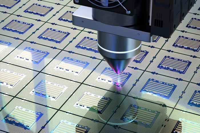 Close-up of semiconductor manufacturing process with laser etching circuits on silicon wafers.