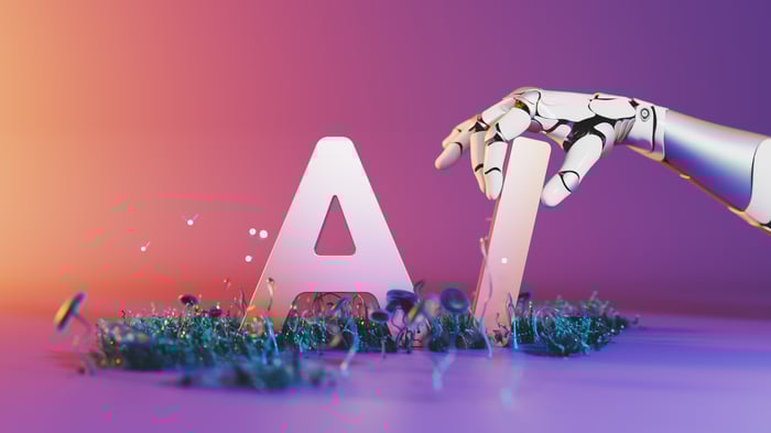 A robotic hand interacting with letters that spell AI.