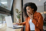 Surprised young woman, laptop