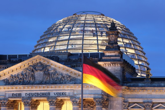 The German flag flies over the Reichstag building in Berlin.