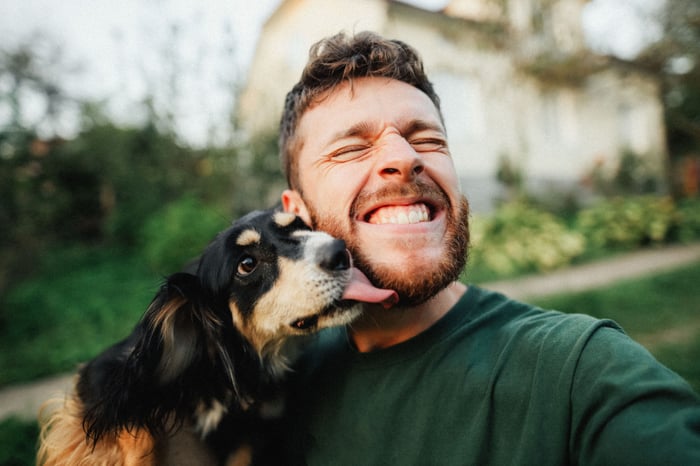 A dog licking its human friend.