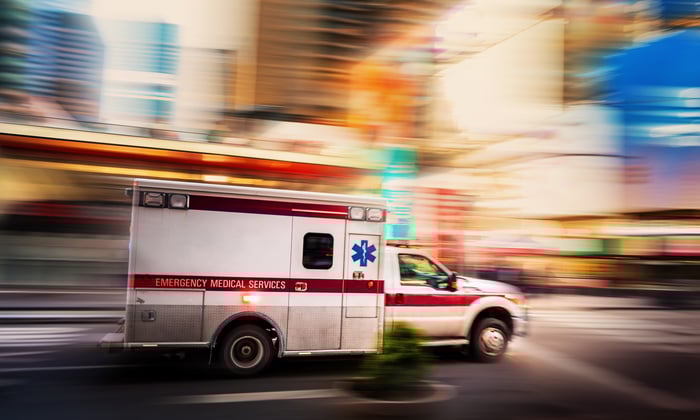 image of ambulance moving quickly down city street.