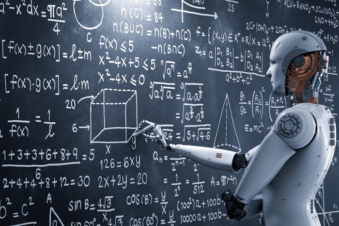 A robot writes complex calculations on a blackboard.
